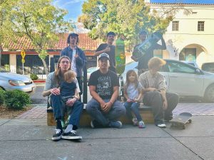 The Aby55 Owners sitting outside their shop with community skaters.